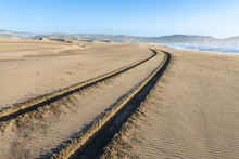 A 4WD Car Track In A Wild Beach Sand Going Towards An Endless Infinite Horizon At The Chilean Coastline In Topocalma Beach, Puertecillo, Chile