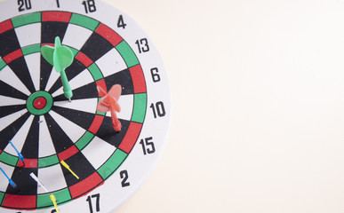 red dart on the middle dart board on the wall