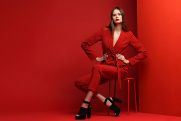 fashion young woman in red suit.