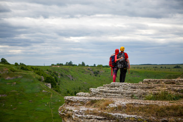 Photo from back of hugging man and woman tourist on mountain