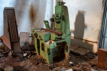 Old industrial machine tool in workshop. Rusty metal equipment in abandoned factory