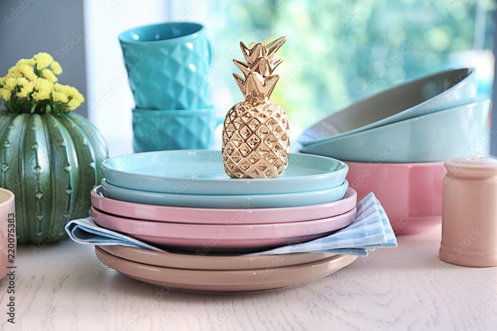 Plates, bowls and cups on white table