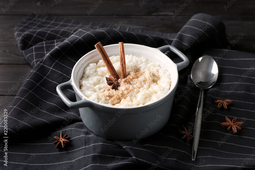 Delicious rice pudding with cinnamon and anise in casserole on table