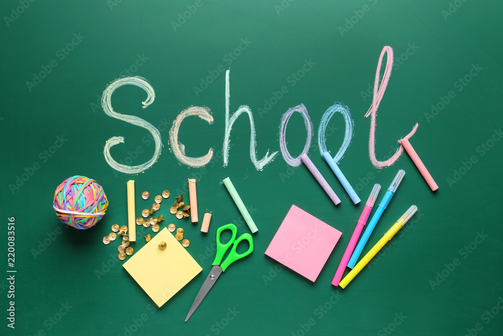 Stationery, papers and word SCHOOL on chalkboard