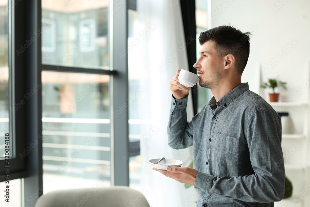 Businessman drinking coffee in office
