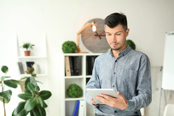 Canvas Print - Businessman with tablet computer in office