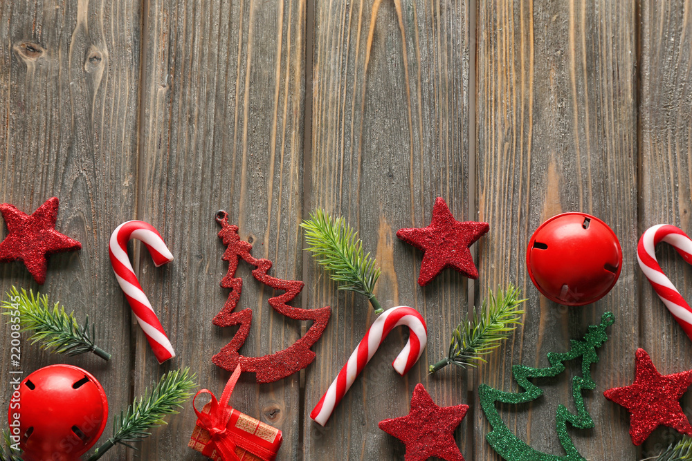Christmas composition with fir branches and festive decorations on wooden background