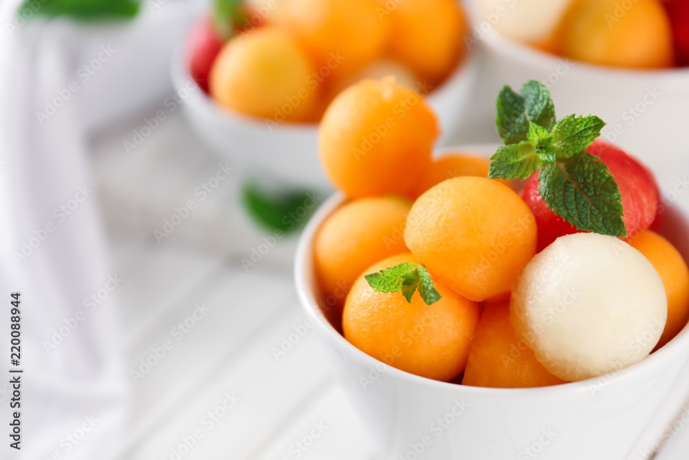 Bowl with tasty melon dessert on table, closeup