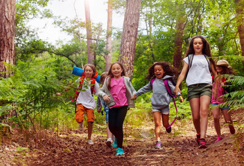 boys and girls running in the forest together