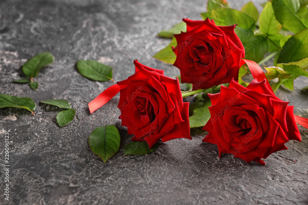 Beautiful bouquet of red roses on grey background