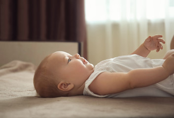 Wall Mural - Cute little baby lying on bed