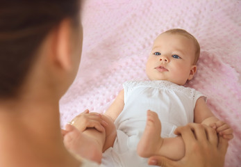 Wall Mural - Mother playing with her little baby at home