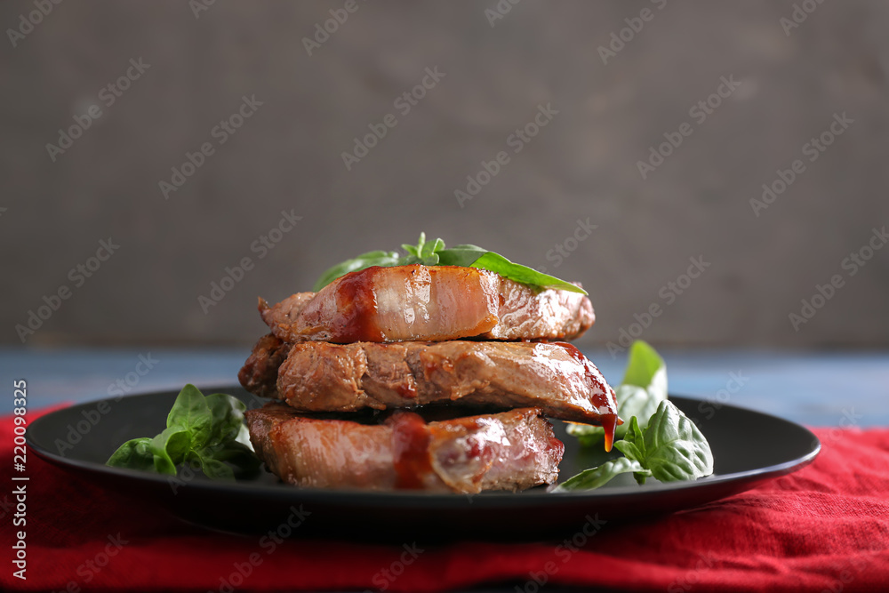 Plate with delicious grilled steaks and sauce on table