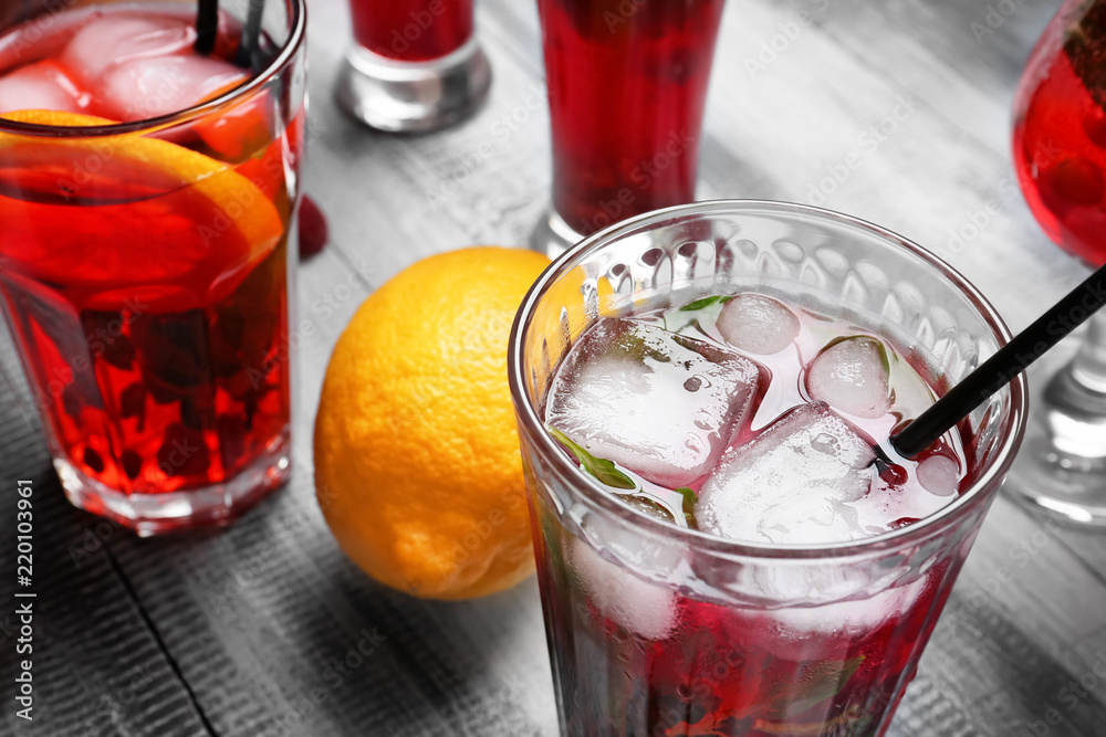 Glasses of fresh raspberry lemonade on wooden table, closeup