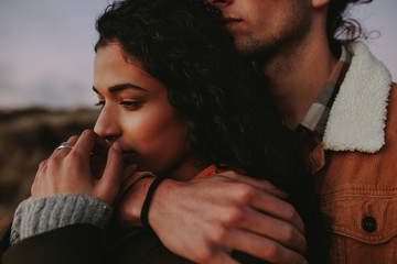 Wall Mural - Woman relaxing in her boyfriend's arms