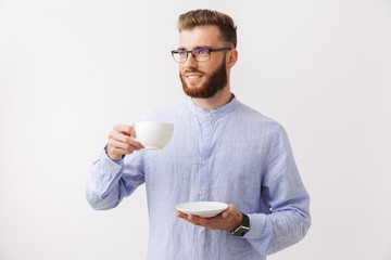 Wall Mural - Portrait of a smiling young bearded man in eyeglasses