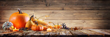 Thanksgiving Background - Pumpkins With Corncob And Candles On Rustic Wooden Table
