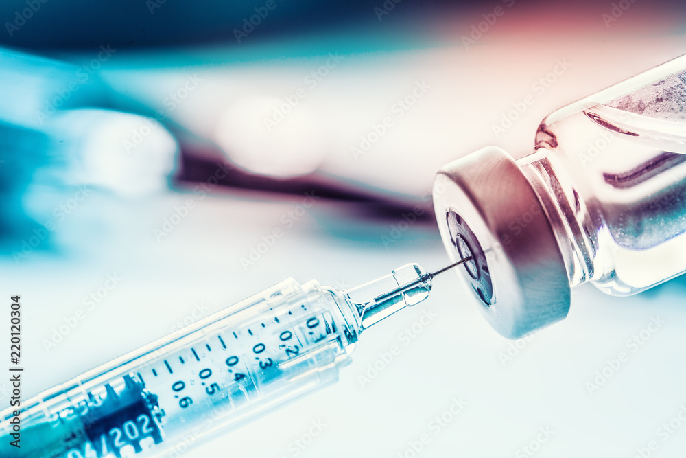 Close-up medical syringe with a vaccine - obrazy, fototapety, plakaty 