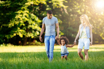 Happy young couple spending time with their daughter