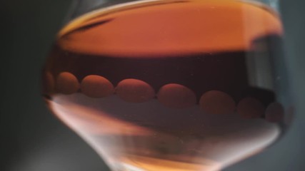 Aufkleber - Glass of alcohol  close up on a dark background, rotation 360 degrees.