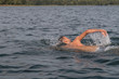 © bohemama - Young man is swimming fast in the lake on a sunny and warm day