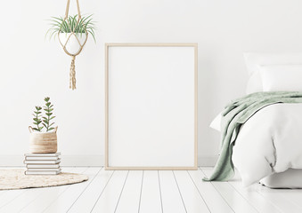 Aufkleber - Poster mockup with wooden vertical frame standing on floor in bedroom interior with bed, green plaid and plants on white wall. 3D rendering.