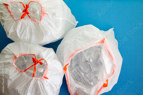 Fotografija Three white bags filled with plastic bottles