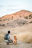 Fototapeta Zwierzęta - man and dog hiking