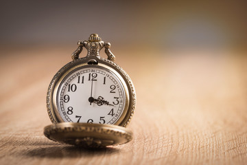 Wall Mural - Pocket watch on wooden background.