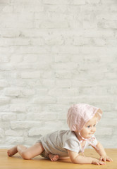 Wall Mural - Portrait of a cute baby girl crawling in the room