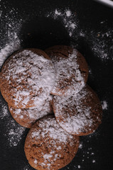 Wall Mural - oatmeal cookies on a black table in castor sugar