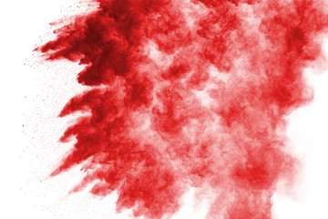 Wall Mural - Freeze motion of red powder exploding, isolated on white background. Abstract design of red dust cloud. Particles explosion screen saver, wallpaper