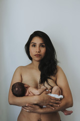 Wall Mural - naked mother holding her infant baby