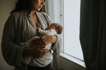 Wall Mural - mother holding her baby indoors