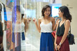 © DragonImages - Beautiful young smiling women shopping in mall