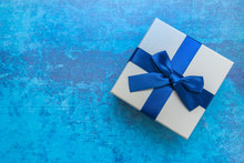 White And Blue Gift Box With Blue Ribbon On Blue Background, Top View. Gifts, Celebration, Valentines Theme