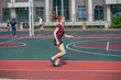 © Михаил Решетников - Red-haired young girl runs in the stadium. Student delivers standards for running outdoors. Young woman running on the football field