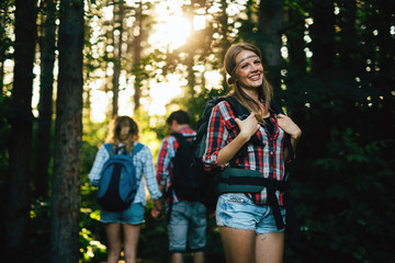 Wall Mural - group of people hiking in forest