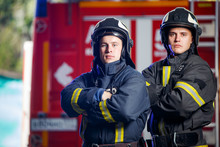Photo Of Two Firemen With Hands On Waist Near Fire Engine