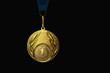 the winner's gold medal for the first place. Isolated on a black background. place for text.