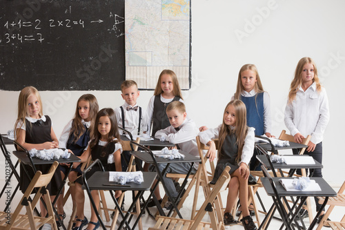 School Children In Classroom At Lesson The Little Boys And Girls