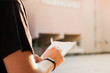 © Photoboyko - Man taking notes outside an educational facility. Young male person's hands holding a notepad and pen and writing information outdoors