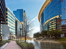 Waterway With Glass Buildings In The Woodlands TX
