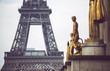 Golden monuments with tower behind in Paris