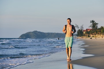 Wall Mural - Man walking on the beach