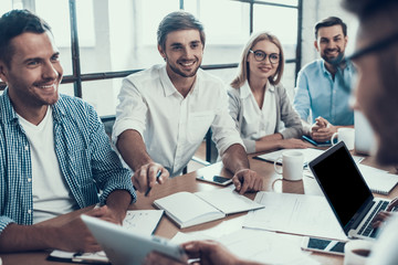 young smiling business people on meeting in office