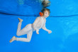 © Andriy Nekrasov - Boy in a white shirt and trousers poses underwater