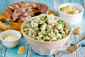 Canvas Print - Pork tongue, mushrooms, fresh cucumber salad on kitchen table with ingredients. Russian cuisine