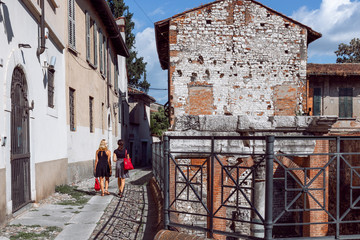 Wall Mural - A small street of Brescia with the Roman historical ruins (Brescia, Lombardy, Italy)