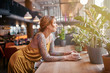 © Andrey Cherlat - beautiful tattooed ginger girl in cafe